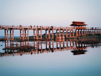 Pier on lake against clear sky