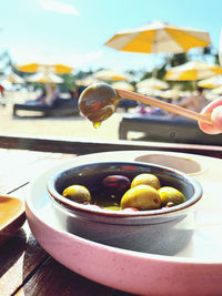 Close-up of hand holding vegetables in bowl