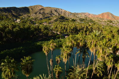 Scenic view of lake and mountains against clear sky