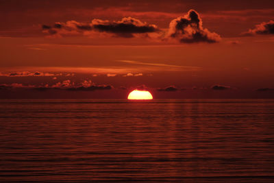 Scenic view of sea against romantic sky at sunset