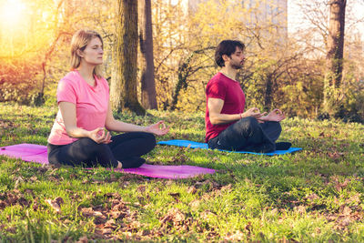 Woman sitting on grass in garden