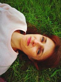 Portrait of smiling woman lying on land