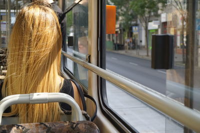 Rear view of woman traveling in bus