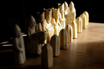 Close-up of candles on table against black background