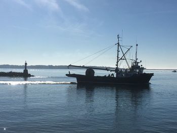 Sailboat sailing on sea against sky