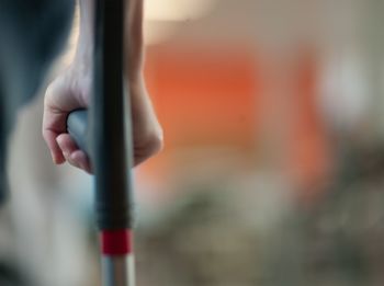 Cropped image of disabled person walking cane