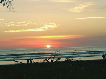 Scenic view of beach against sky during sunset