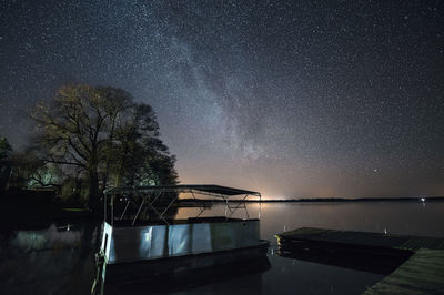 Scenic view of tree against sky at night