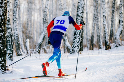 Man skiing on snow covered land