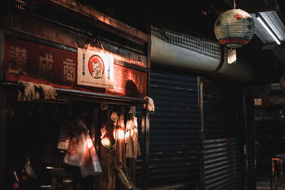 Low angle view of illuminated lanterns hanging in store