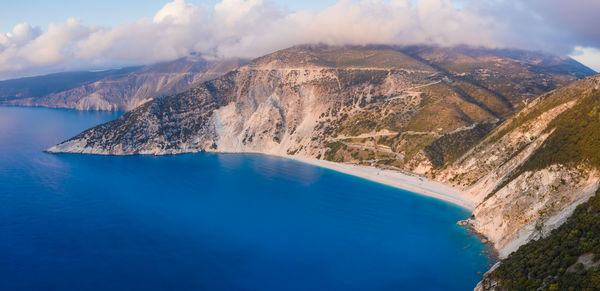 Aerial view of sea and mountains against sky