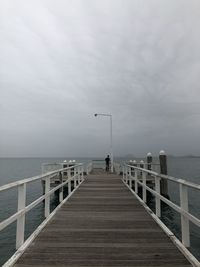 Pier over sea against sky