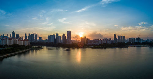 City at waterfront during sunset
