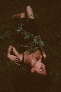 Rear view of a young woman sitting outdoors