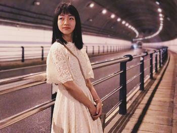 Portrait of young woman standing indoors