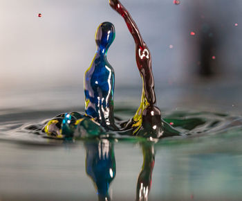 Close-up of water drop on sea against sky