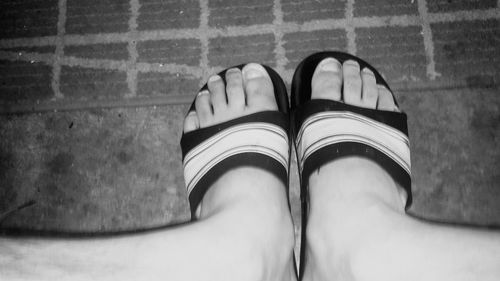 Close-up of woman standing on tiled floor