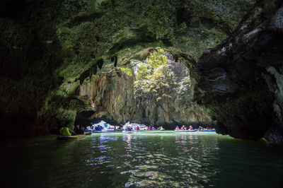 Group of people on rock in water