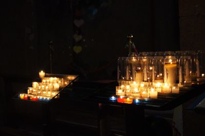 Illuminated candles against sky at night