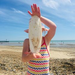 Man holding ice cream on beach