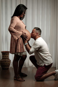 Side view of couple standing at home