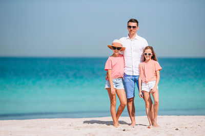 Full length of sunglasses on beach