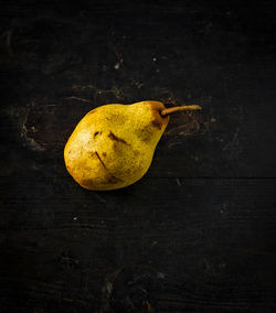 Close-up of yellow fruit against black background