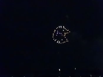 Low angle view of fireworks in sky at night