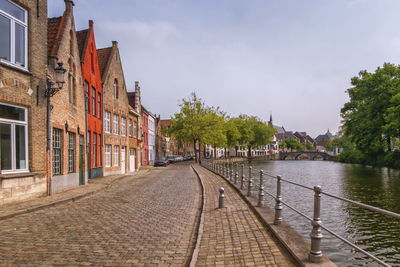 Red brick houses in the traditional dutch style and canal in bruges, belgium