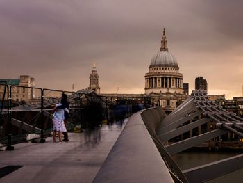 Buildings in city against sky during sunset