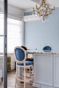 Classic high chairs in a bright interior with a golden chandelier