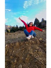 Portrait of happy young woman against sky