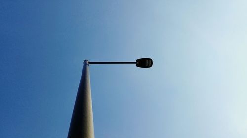 Low angle view of street light against blue sky