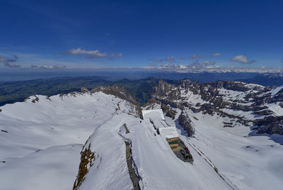 Scenic view of snow covered mountains against sky