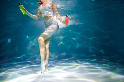 High angle view of woman swimming in pool