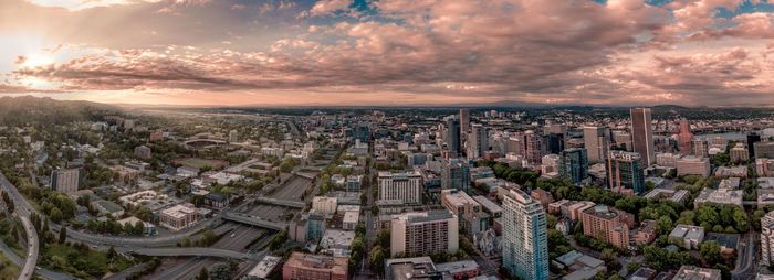 High angle view of city against cloudy sky during sunset