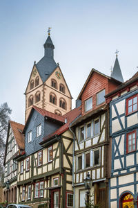 Street with historic half-timbered houses and st. mary church in gelnhausen, germany