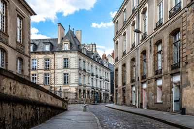 Street amidst buildings in town against sky