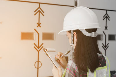 Rear view of female engineer working