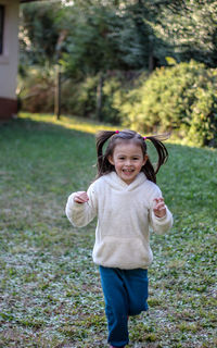 Portrait of smiling girl standing on grass