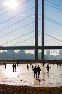 People on beach against clear sky