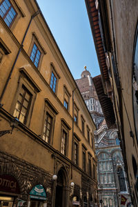 Low angle view of buildings in city against sky