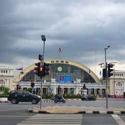 Vehicles on road against buildings in city