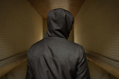 A man in a hood on the street. social problems, drug addiction and criminal activity. 