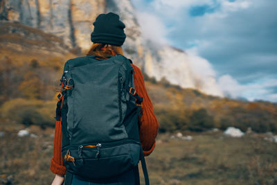 Rear view of man looking at camera