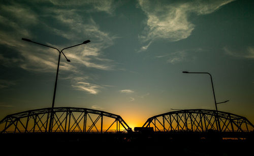 Low angle view of silhouette bridge against sky during sunset