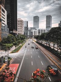 High angle view of city street and buildings against sky