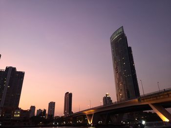 Low angle view of illuminated buildings against sky during sunset