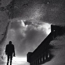 Silhouette of woman against cloudy sky