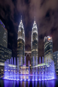 Illuminated modern buildings in city at night